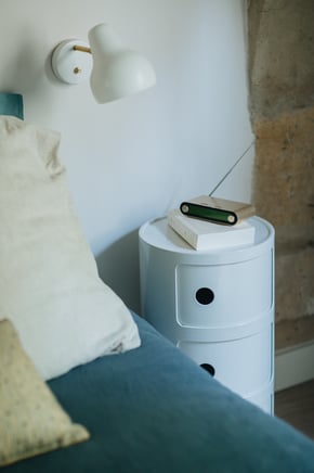Chevet Componibili (Kartell), applique VL 38 (Louis Poulsen), coussins (Le Monde Sauvage).